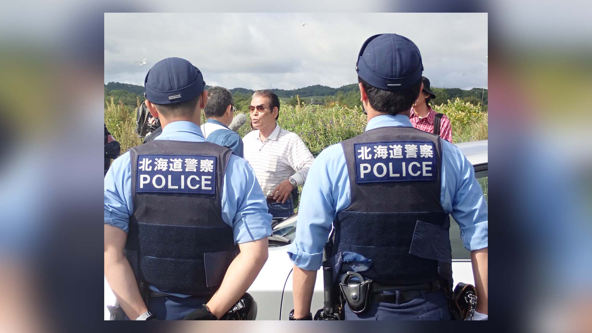 Hokkaido Police hinder Hatakeyama Satoshi from taking salmon. Photo by Yousuke Kosaka, 31 August, 2018. Criminalising Rituals and Traditional Occupations: The Struggle of Ainu in Japan, A Century Hence